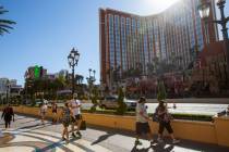 People walk down the Strip in front of Treasure Island in Las Vegas in July 2020. (Las Vegas Re ...