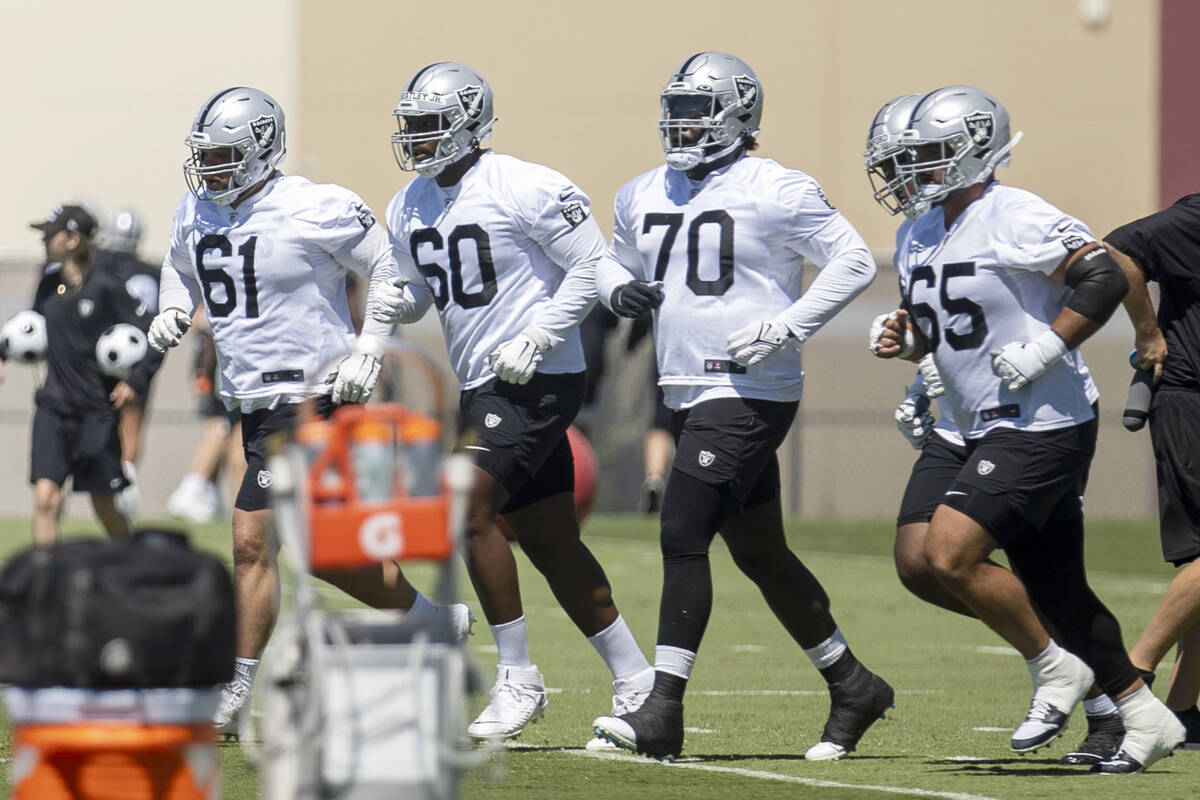 Raiders offensive linemen, from left, Jordan Meredith (61), Tyrone Wheatley, Jr. (60), Alex Lea ...