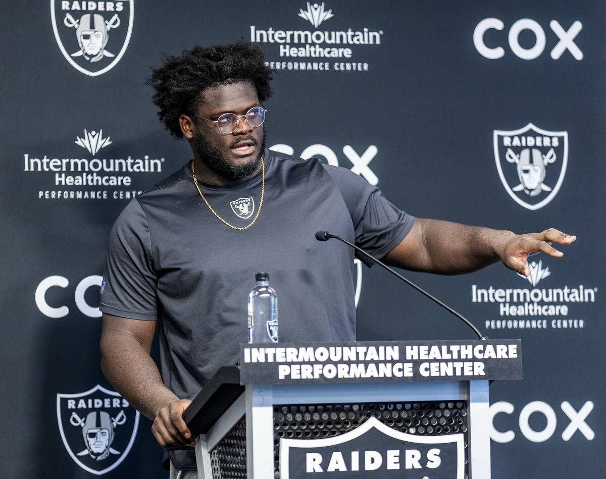 Raiders offensive lineman Alex Leatherwood (70) answers a media question during minicamp practi ...