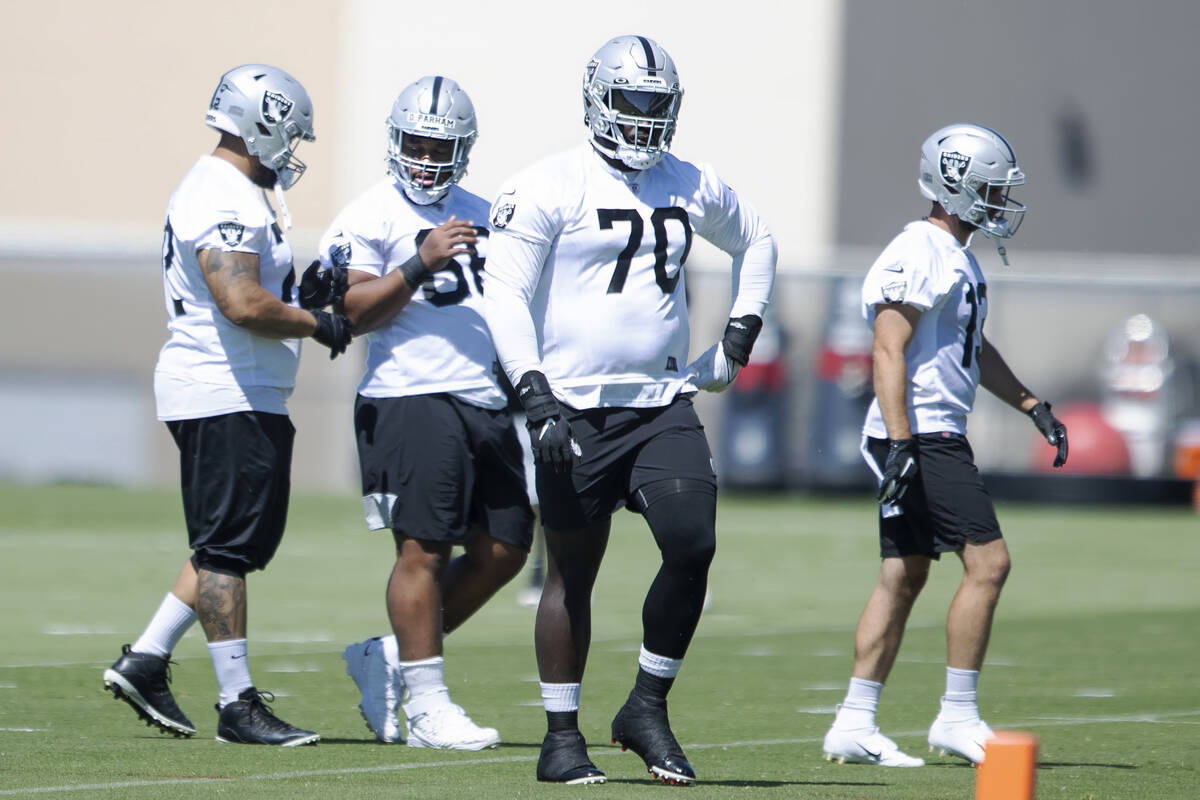 Raiders offensive lineman Alex Leatherwood (70) walks to a drill during the team’s manda ...