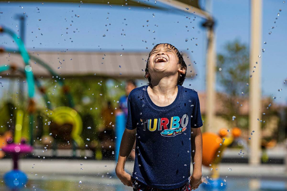 Zac Harris, 8, visiting from Kansas City, Mo., plays in the water at Trigono Hills Park on Wedn ...