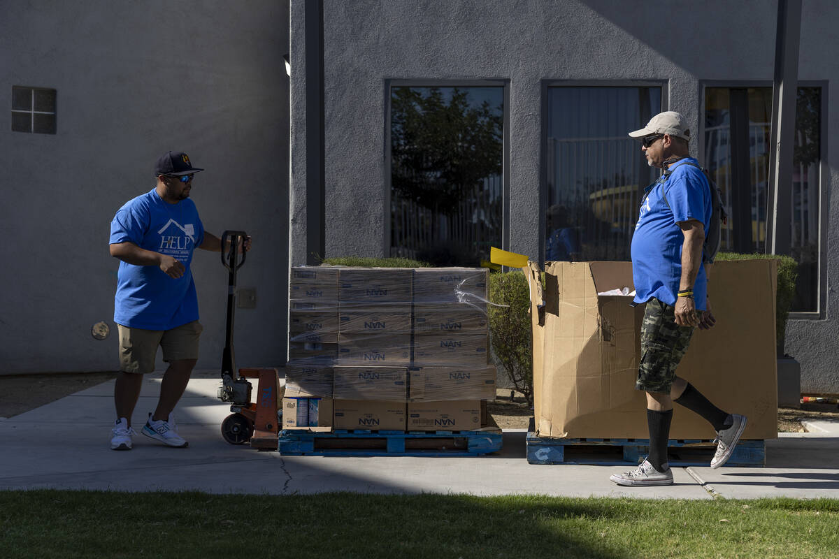 Volunteers load palettes of baby formula as HELP of Southern Nevada gives out baby supplies to ...