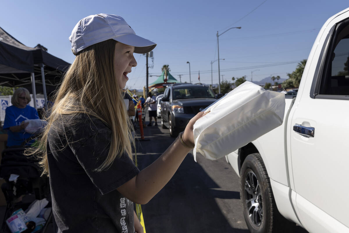 Lauren Funai, 13, volunteers with HELP of Southern Nevada as they give out baby formula and bab ...