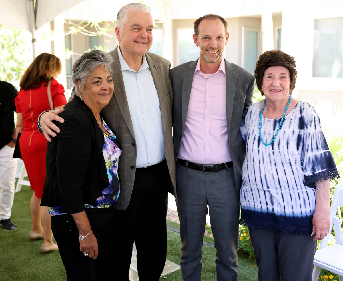 Gov. Steve Sisolak, second from left, and Clark County Commissioner Justin Jones pose with resi ...