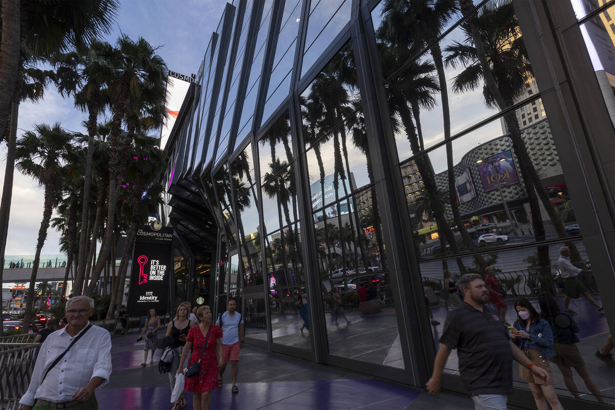 Pedestrians walk along Las Vegas Boulevard outside The Cosmopolitan, Wednesday, June 8, 2022, o ...