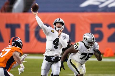 Raiders quarterback Derek Carr (4) gets a pass away with pressure from Denver Broncos defensive ...
