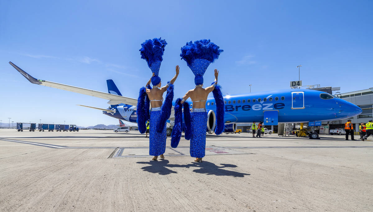 Showgirls Brooke, left, and Tara welcome passengers for the Breeze Airways inaugural flight arr ...