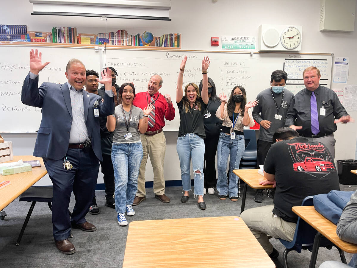 Move 4 Less Canyon Springs High School English teacher Martin Vece, center in red shirt, was na ...