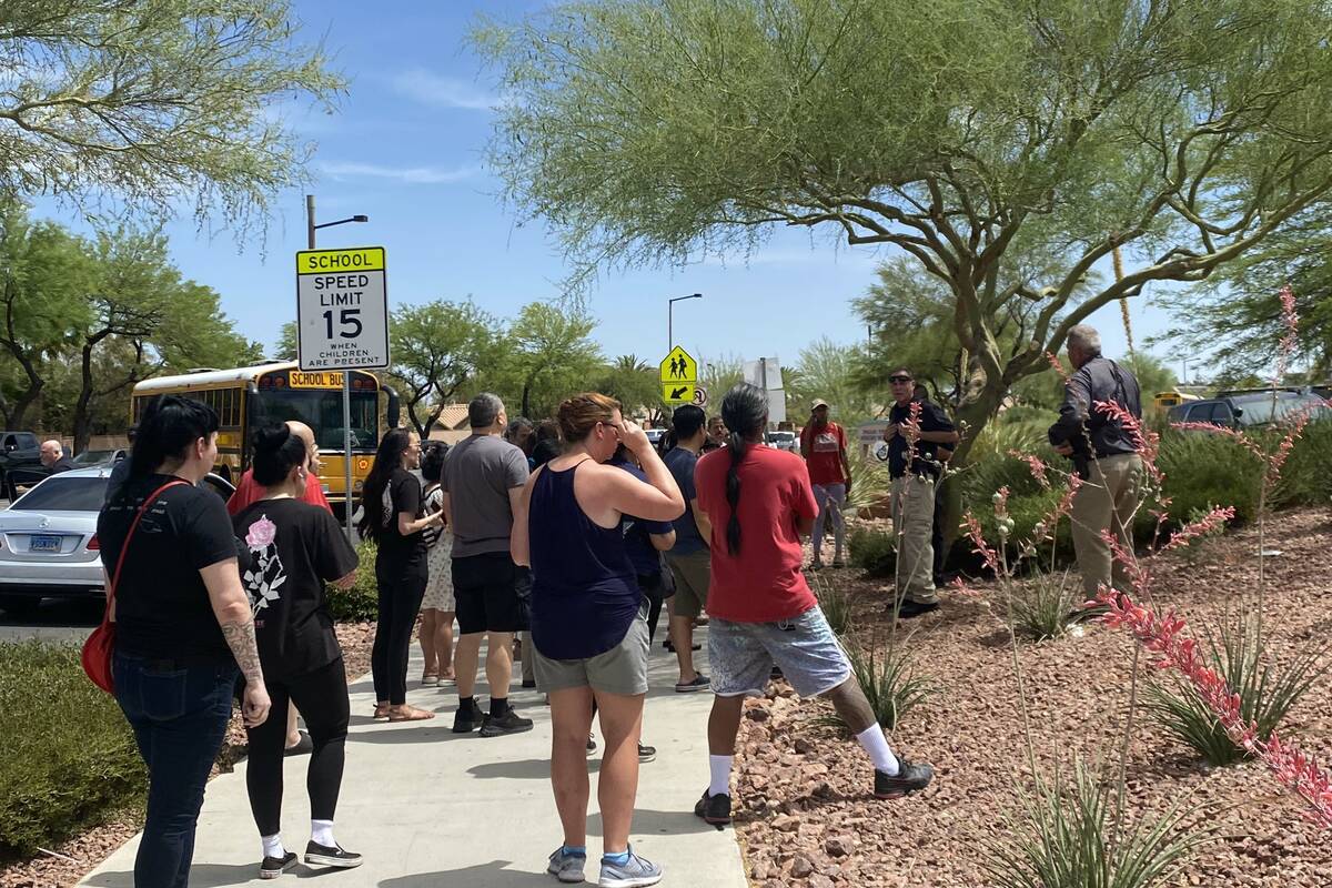 Police and onlookers congregate at Palo Verde High School on Thursday, June 9, 2022. (Glenn Pui ...