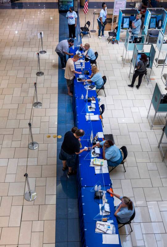 Area residents are assisted by the Clark County Election Department personnel on the last day o ...