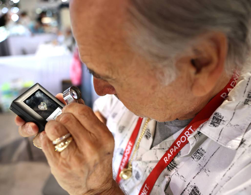 A jeweler who declined to give his name checks out a 10 carat heart diamond during the Las Vega ...