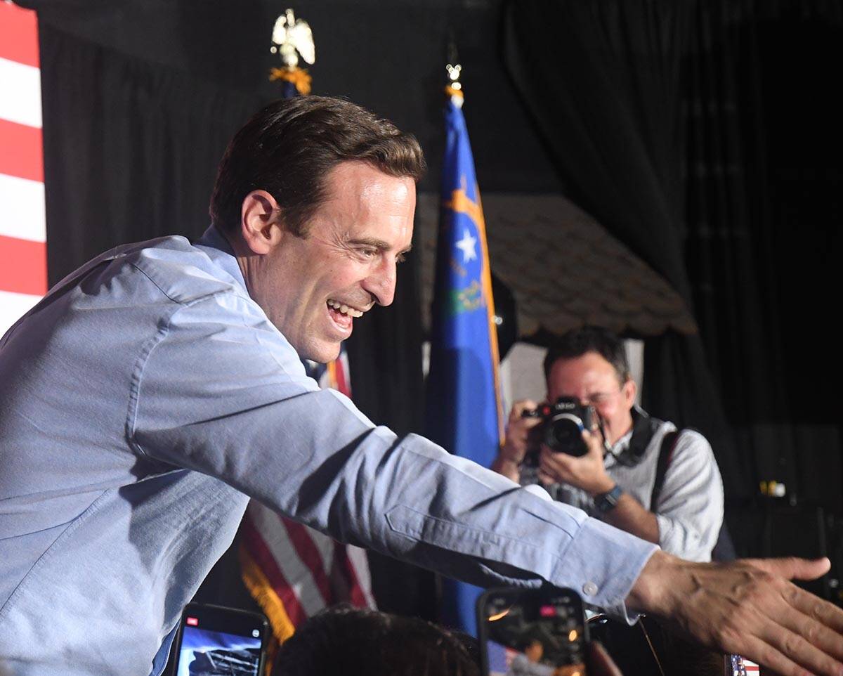 Nevada U.S. Senate candidate Adam Laxalt shakes hands with attendees at a rally in Las Vegas on ...