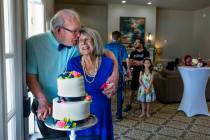 Groom John Hansell, left, and his new bride Carolyn Brylinski share a moment by their wedding c ...