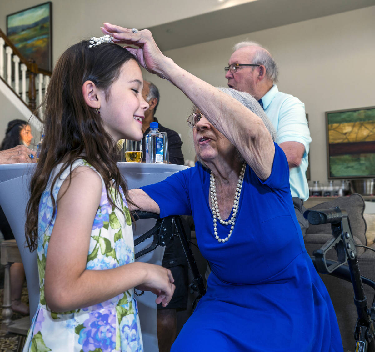 Bride Carolyn Brylinski, center, puts her hair piece on her great-granddaughter Payton Downey, ...