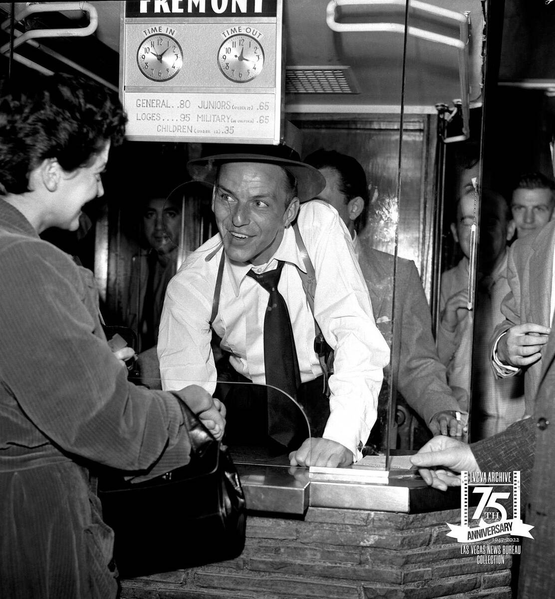 Frank Sinatra at the ticket window of the Fremont Theatre for the premier of his movie Suddenly ...