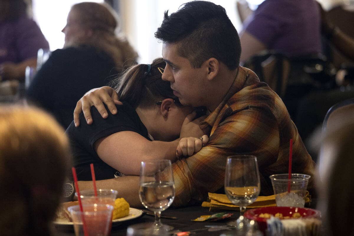 Cailin Hickson, a cousin of Tiffany Booth, hugs her fiancé Luis Munoz during a memorial se ...