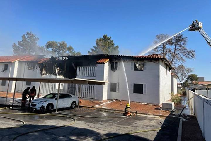 A snorkel sprays water on an apartment building after a fire at Lantana Apartments, 1200 S. Tor ...