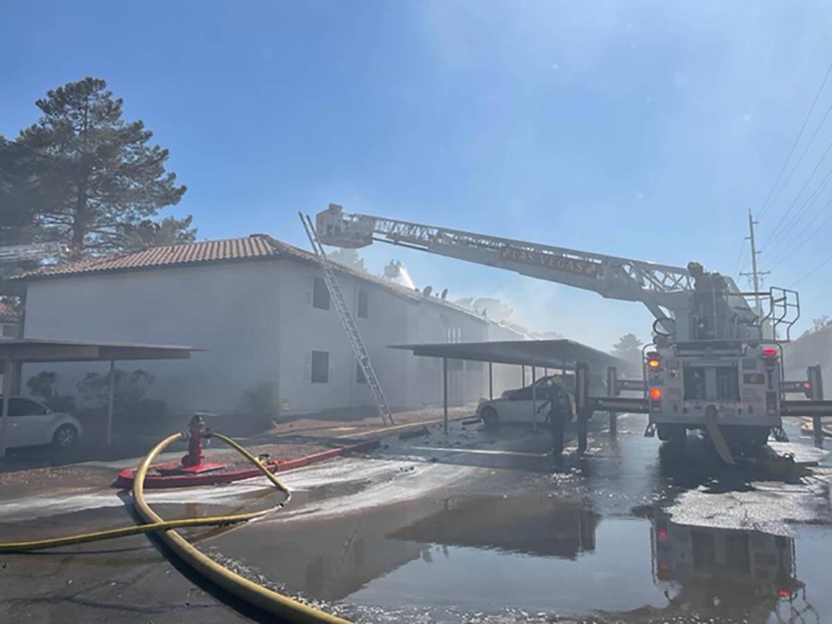 A snorkel sprays water on an apartment building after a fire at Lantana Apartments, 1200 S. Tor ...