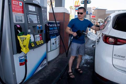 Mike Lee, of Las Vegas, pumps gas at a Chevron station on East Sahara Avenue on Monday, June 6, ...