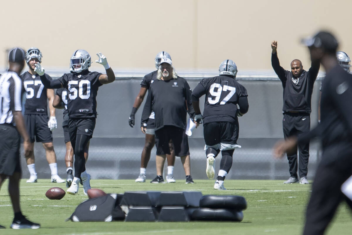 Raiders linebacker Jayon Brown (50) raises his arms to communicate a drill being called by the ...