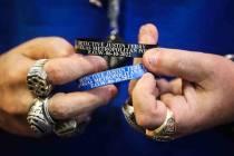 Neil Sackmary, owner of Nevada Coin Mart, holds bracelets that are being sold online through th ...