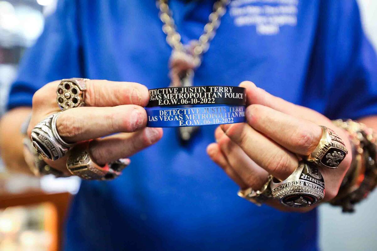 Neil Sackmary, owner of Nevada Coin Mart, holds bracelets that are being sold online through th ...