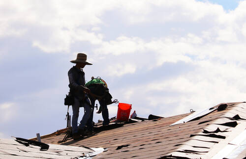 Construction workers labor on rooftops in sweltering heat at the Coronado Condominiums in Summe ...
