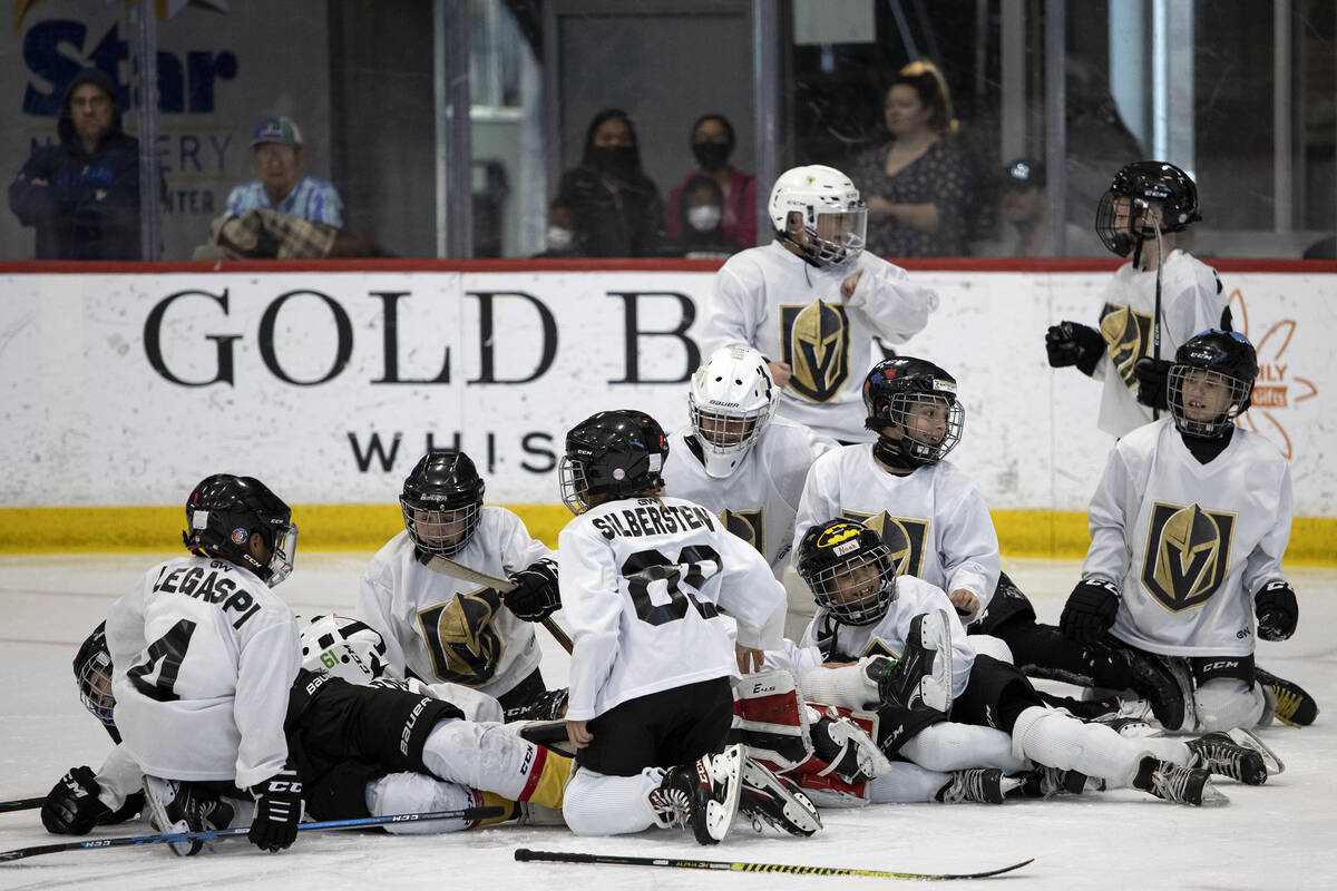 The Mavericks tackle their goaltender after winning a 10U Jr. Golden Knights Hockey League game ...