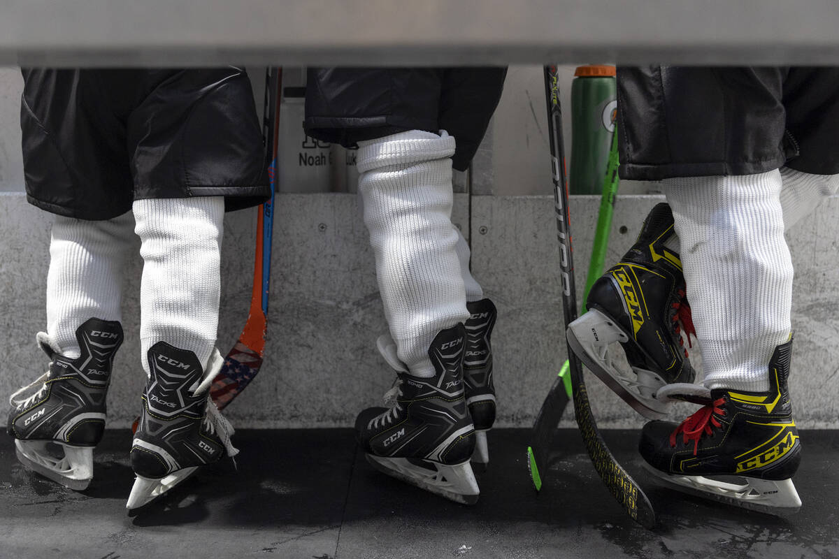 Members of the Mavericks ride the bench during a 10U Jr. Golden Knights Hockey League game agai ...