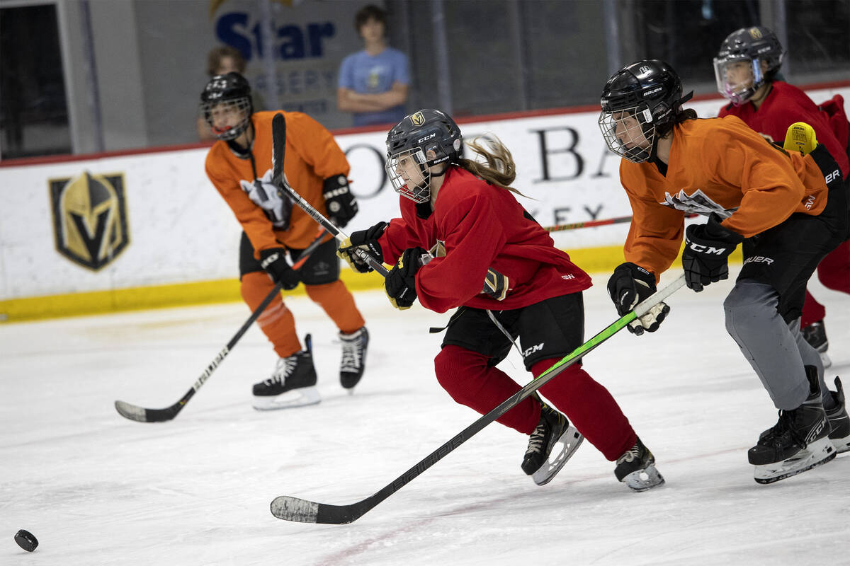 The Red Raptors and the Miners skate for the puck during a 14U Jr. Golden Knights Hockey League ...