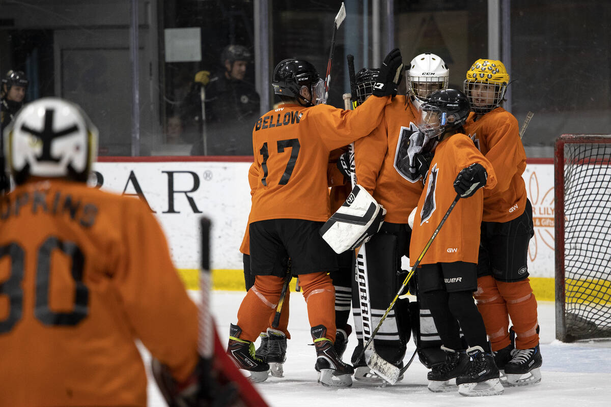 The Miners congratulate their goaltender after winning a 14U Jr. Golden Knights Hockey League g ...