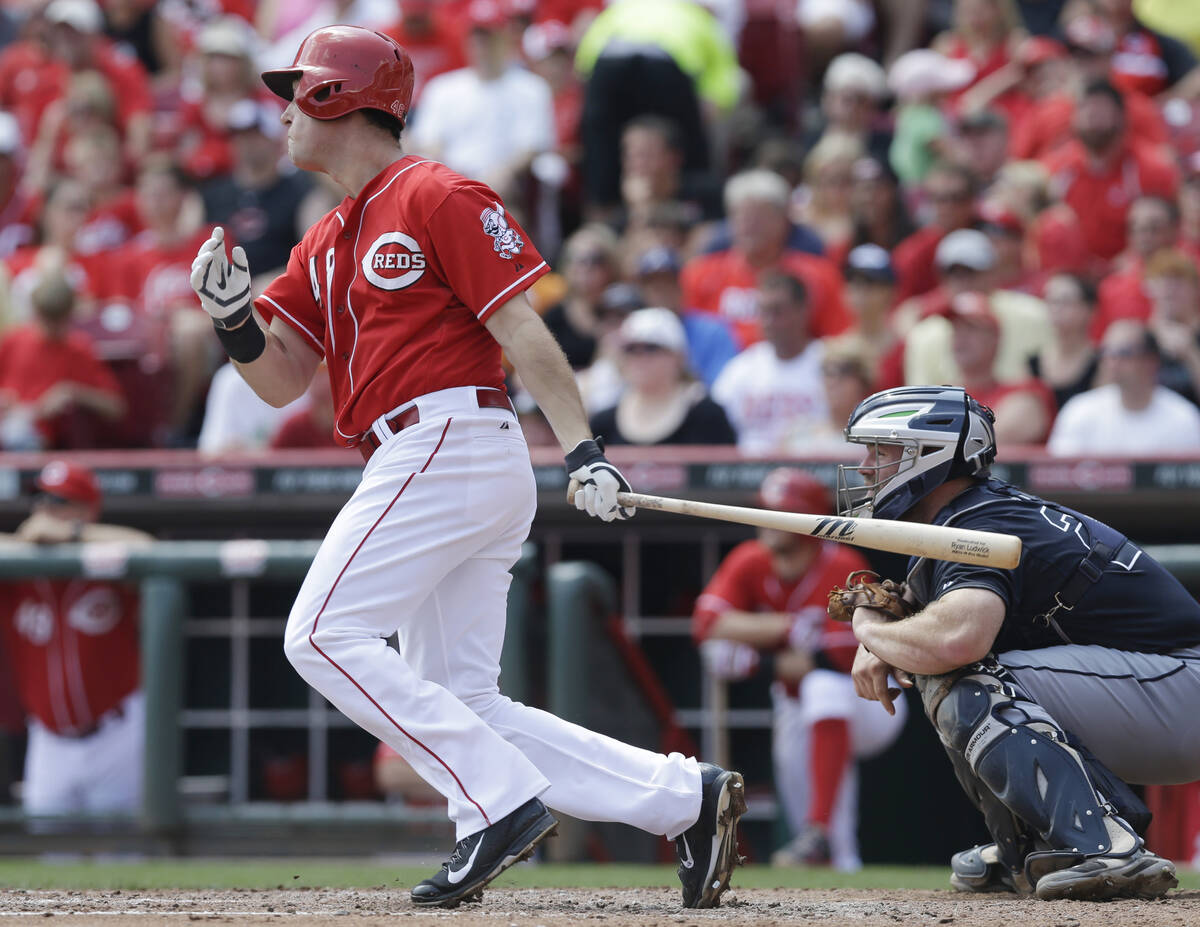 Cincinnati Reds' Ryan Ludwick hits a sacrifice fly off Atlanta Braves starting pitcher Aaron Ha ...