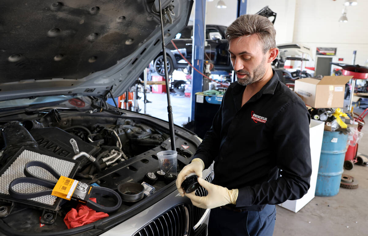 Victor Botnari, owner of Universal Motorcars in Las Vegas, shows a pulley that melted from heat ...