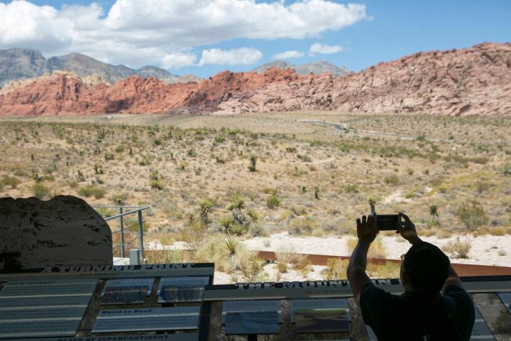 Visitors take photos at the Red Rock Canyon National Conservation Area's visitor center in Augu ...