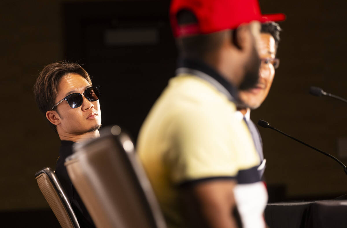 Mikuru Asakura, left, looks on as Floyd Mayweather talks about an exhibition boxing match betwe ...