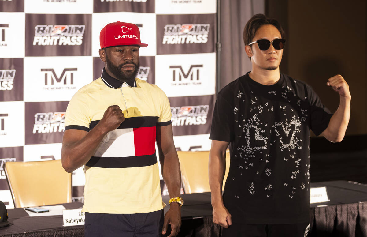 Floyd Mayweather, left, and Mikuru Asakura pose ahead of their exhibition boxing match, which i ...