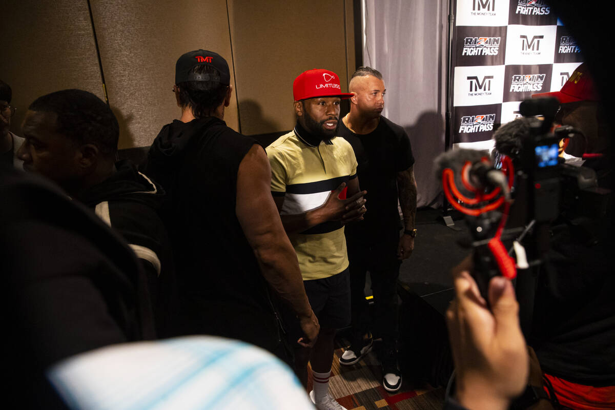 Floyd Mayweather talks with reporters after announcing an exhibition boxing match, that he is s ...