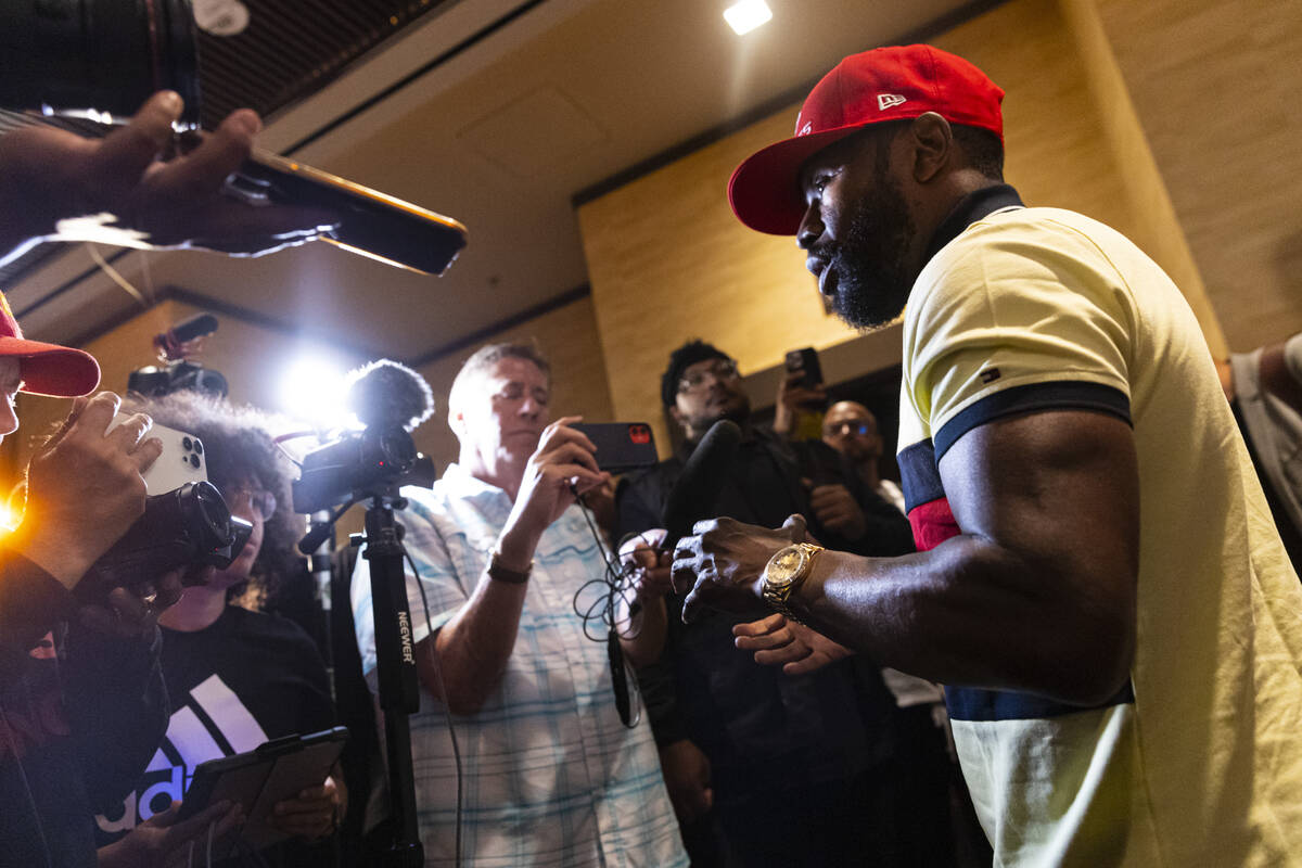 Floyd Mayweather talks with reporters after announcing an exhibition boxing match, that he is s ...