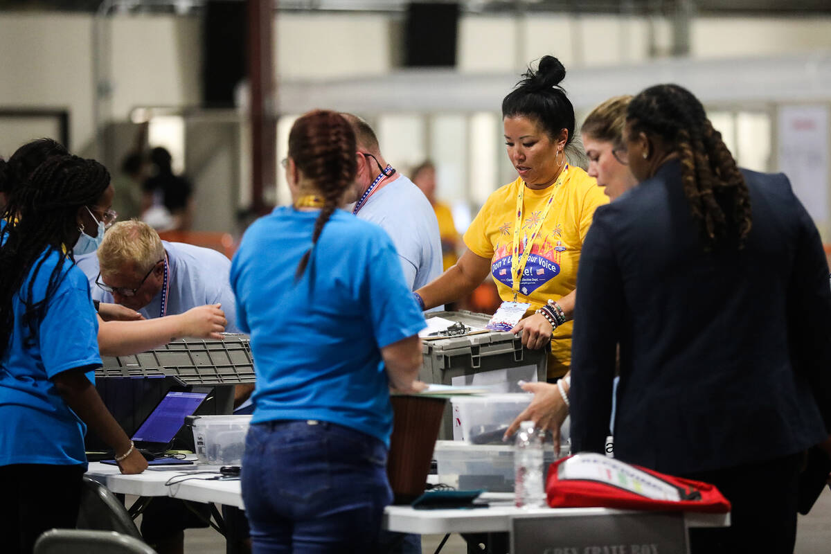 Election workers process boxes of ballots at the Clark County Election Department in North Las ...