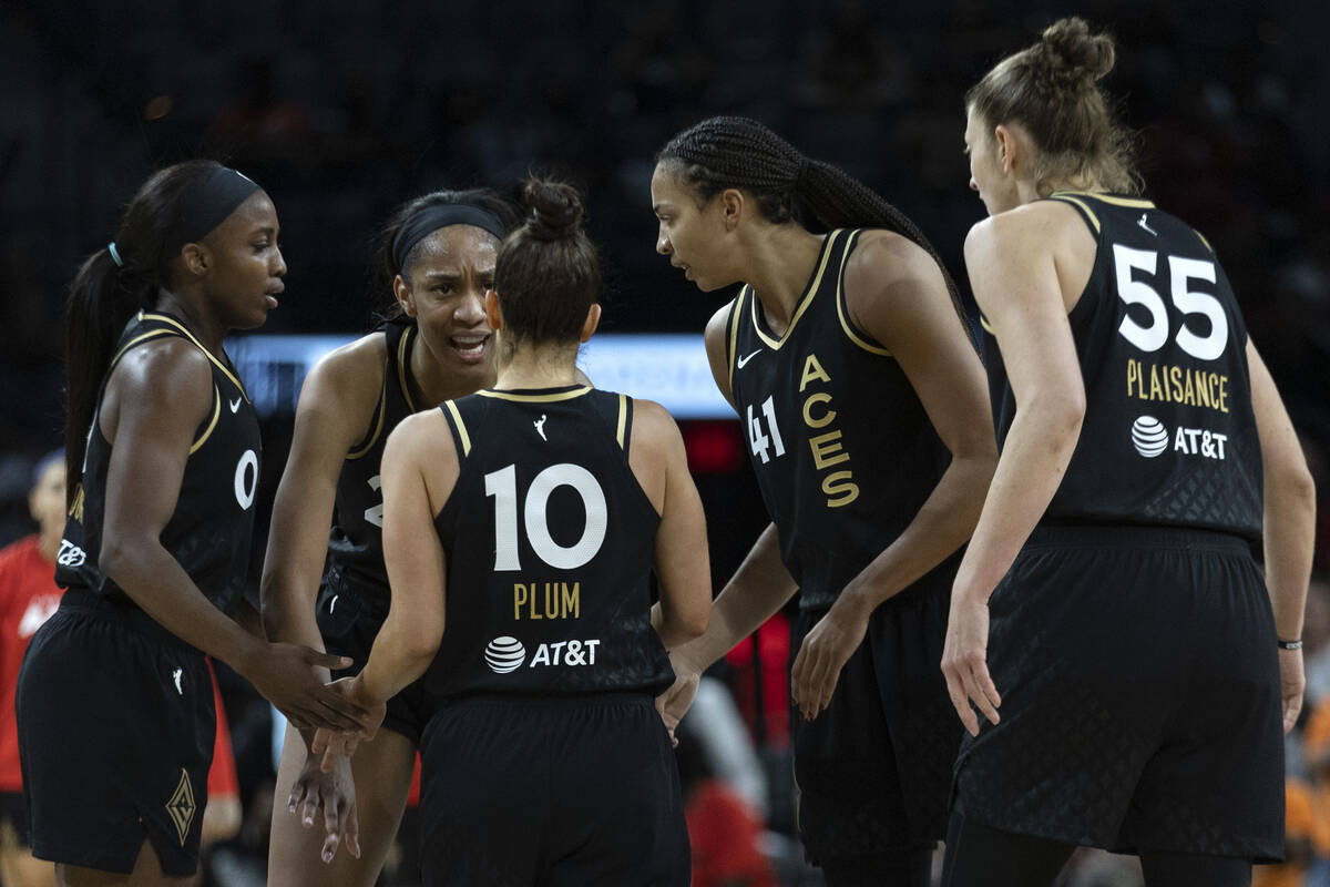 Las Vegas Aces players communicate in between plays during the second half of a WNBA basketball ...