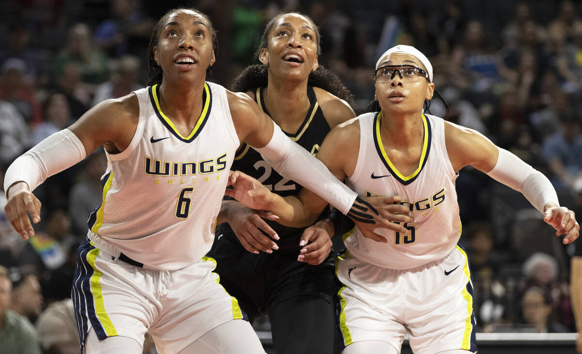 Aces forward A'ja Wilson (22) fights for a rebound with Dallas Wings forward Kayla Thornton (6) ...