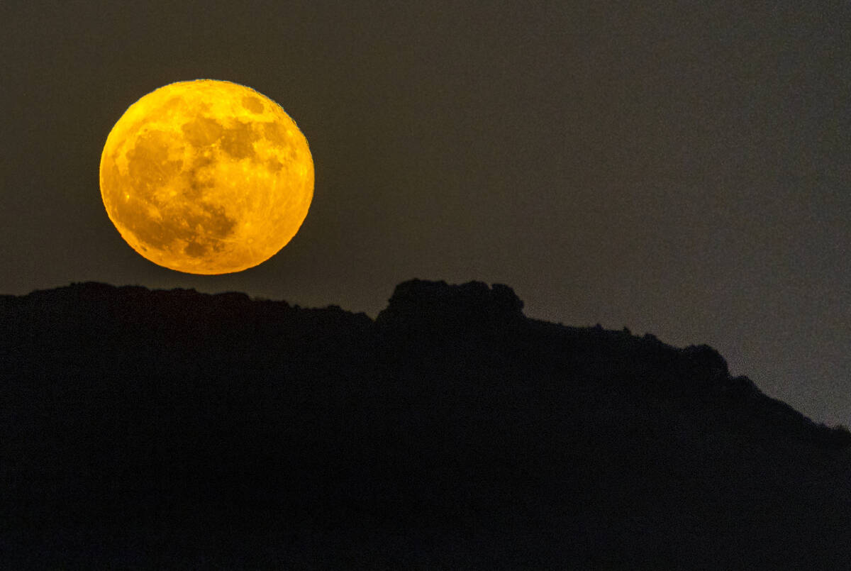 A Strawberry Supermoon rises over the city on Tuesday, June 14, 2022, in Las Vegas. (L.E. Basko ...