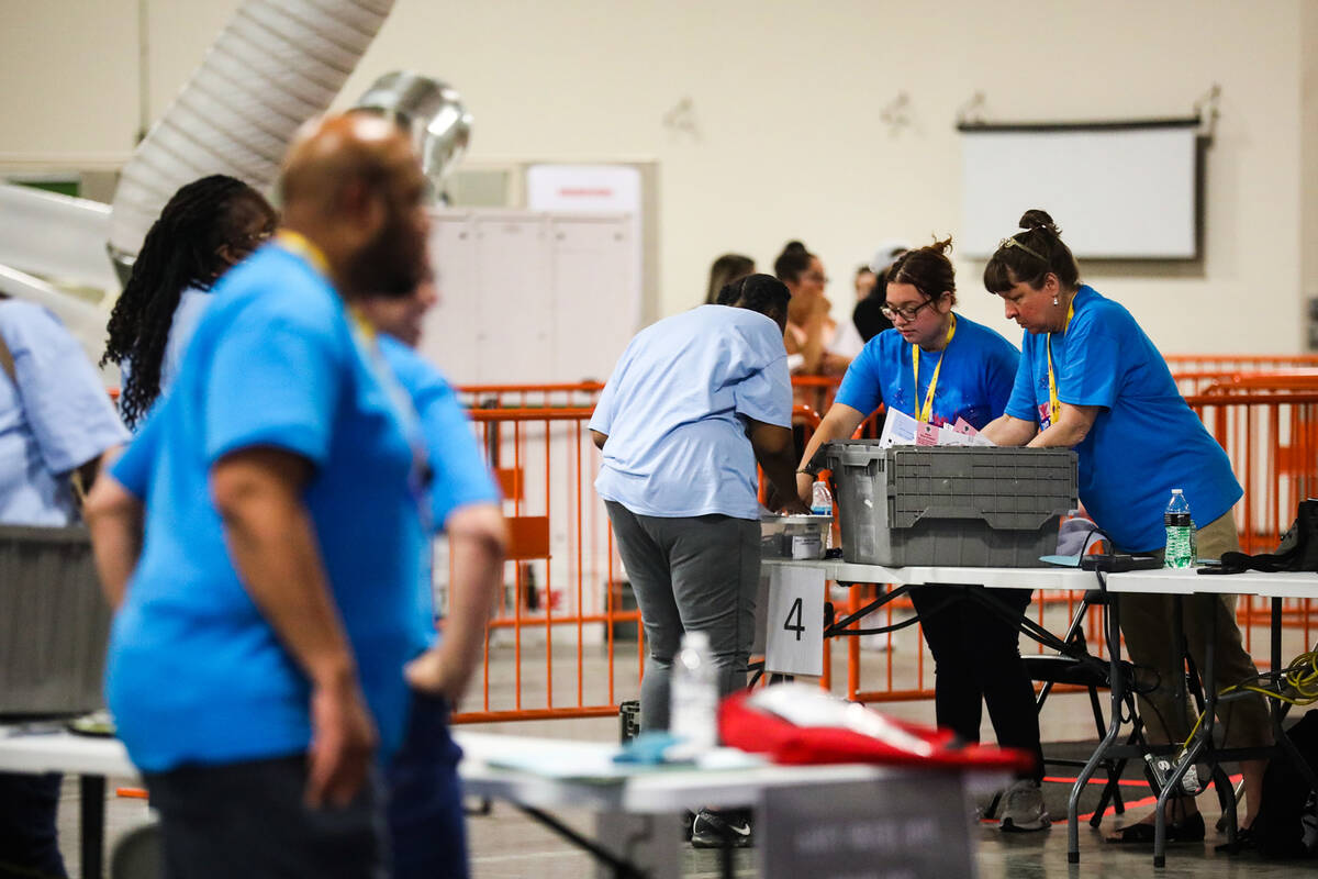 Election workers process boxes of ballots at the Clark County Election Department in North Las ...