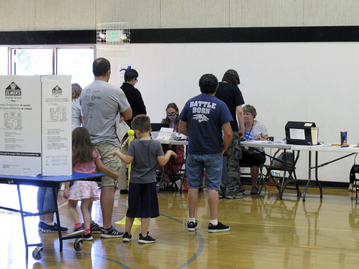 Washoe County voters line up inside a gymnasium at Reed High School in Sparks, Nev. on Tuesday, ...