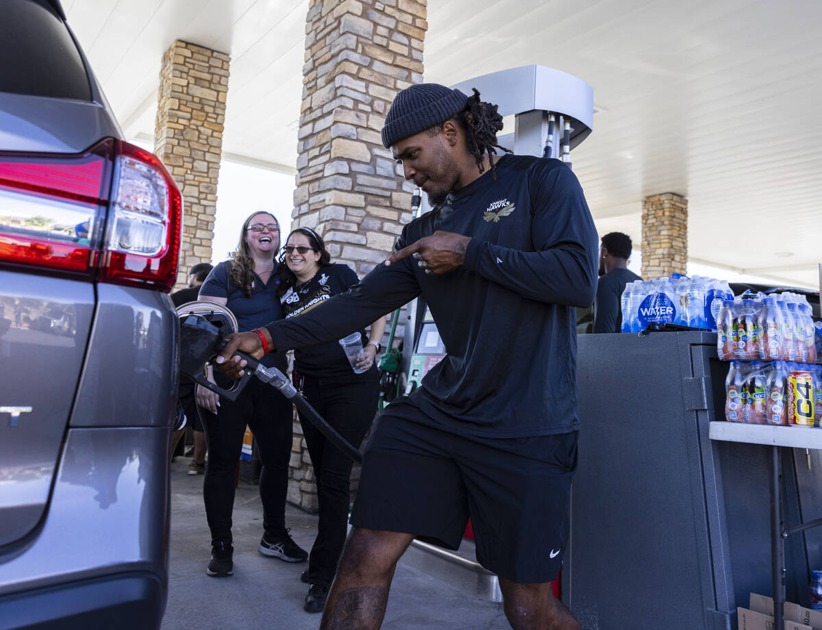 Vegas Knight Hawks linebacker Gabriel McCoy pumps gas to a customer as Smith’s Assistanc ...
