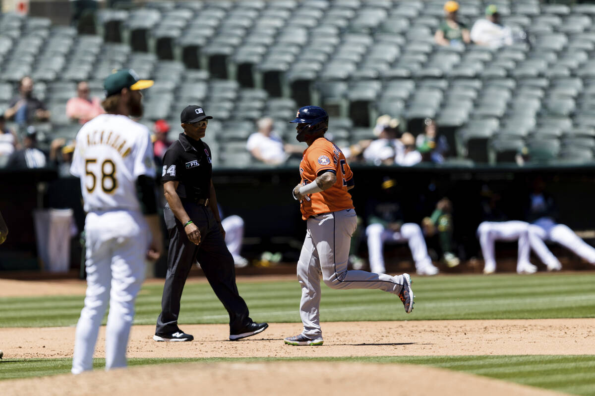 As Oakland Athletics starting pitcher Paul Blackburn (58) looks on, Houston Astros' Jose Altuve ...