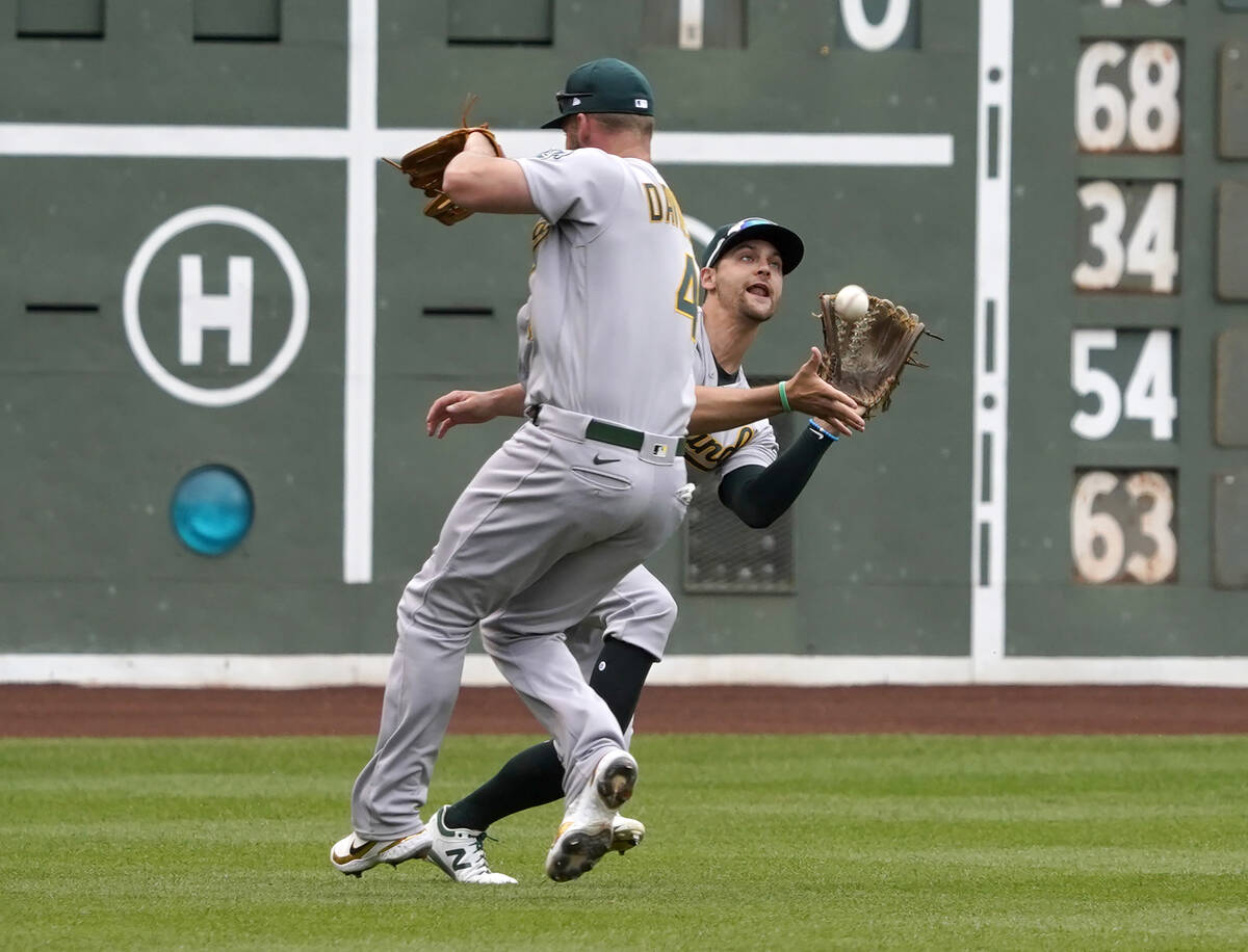 Oakland Athletics left fielder Chad Pinder catches a fly ball hit by Boston Red Sox' Rafael Dev ...