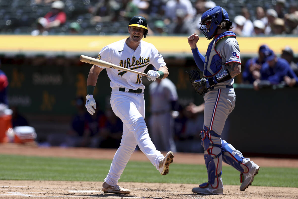 Oakland Athletics' Sean Murphy (12) reacts after striking out in front of Texas Rangers catcher ...