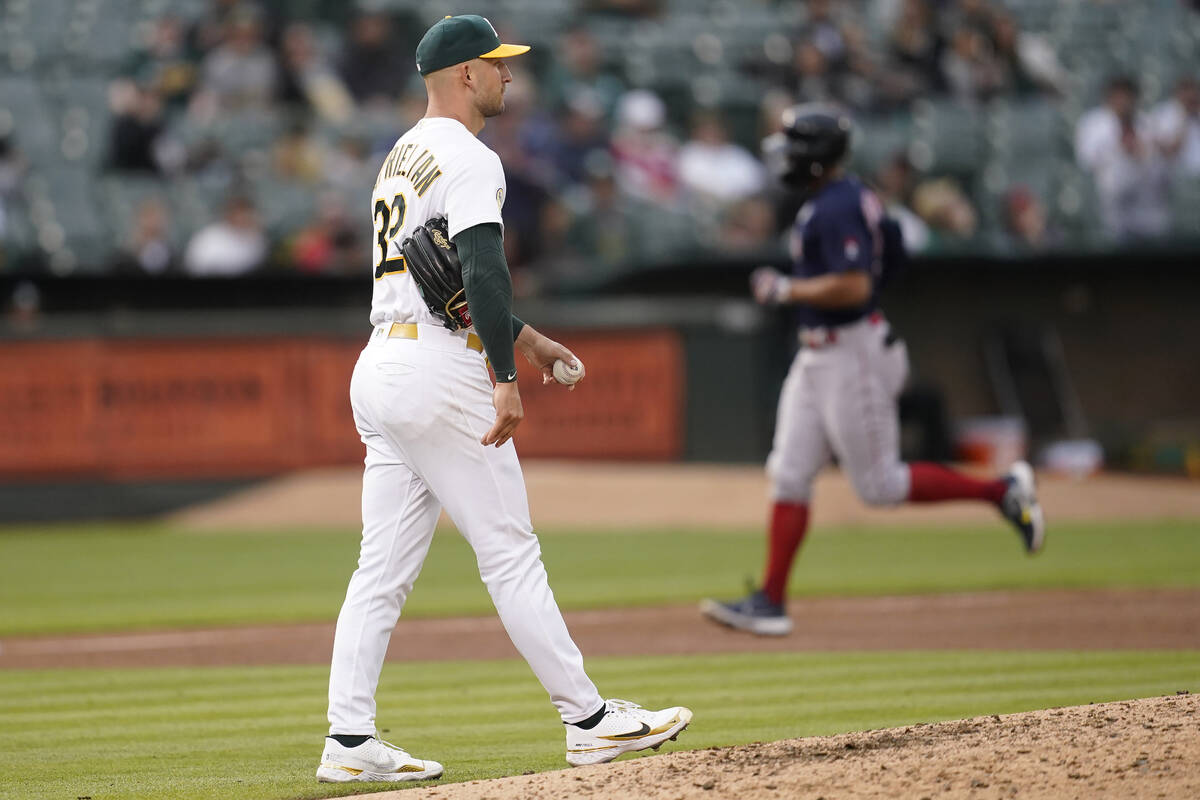 Boston Red Sox's Xander Bogaerts, rear, runs the bases after hitting a home run off Oakland Ath ...