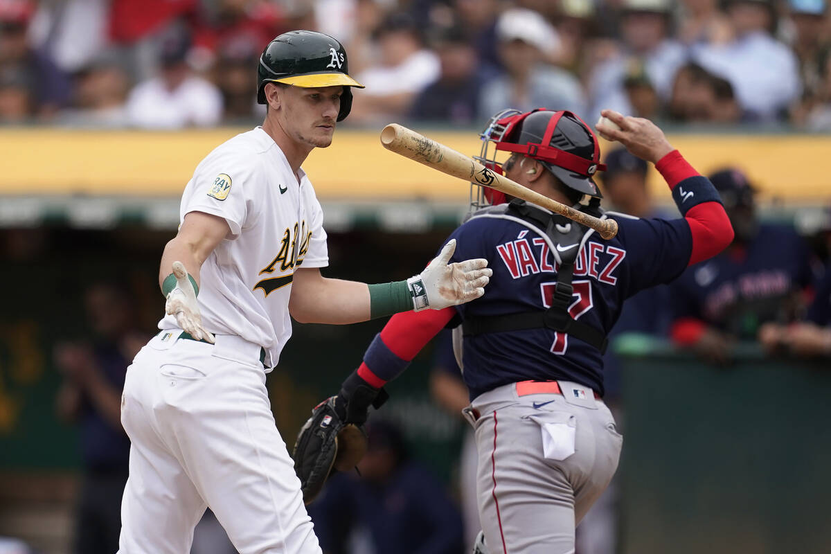 Oakland Athletics' Sean Murphy, left, reacts after striking out next to Boston Red Sox catcher ...